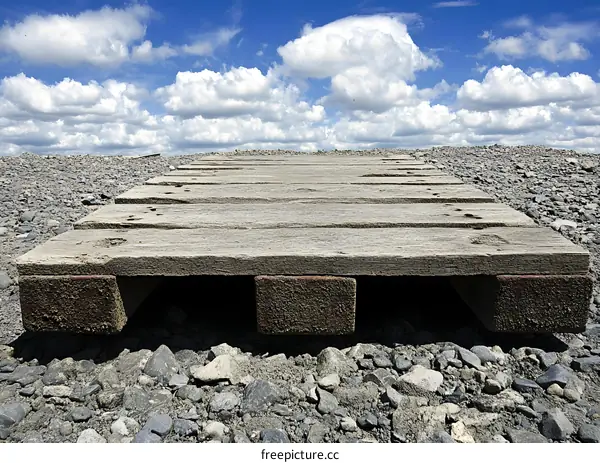 Wooden Pallet on Gravel Under Blue Sky