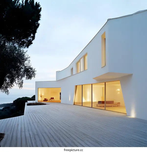 Modern White House with Large Windows and Deck Overlooking the Sea