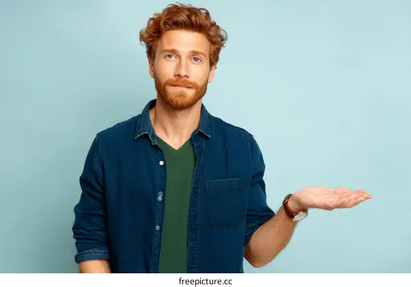 Man in Denim Shirt Presenting Something