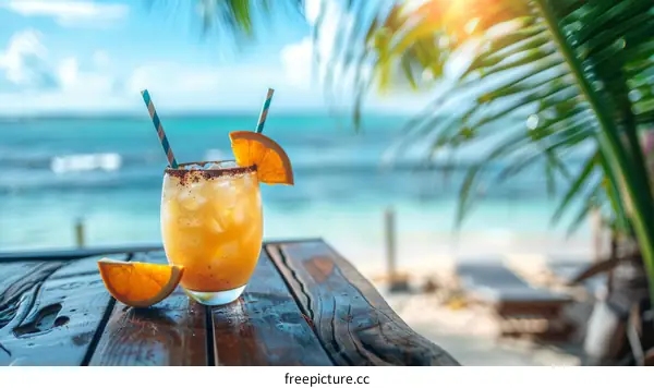 Tropical Orange Cocktail at Sunset on the Beach
