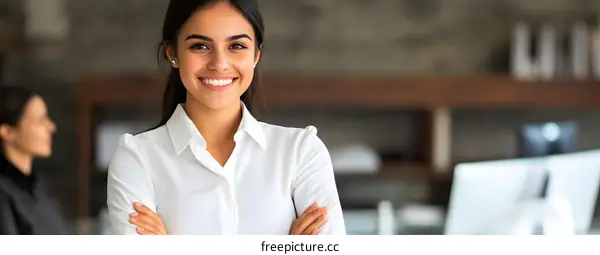 Smiling Businesswoman with Arms Crossed in Office Setting