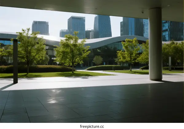 Modern urban plaza with greenery and tall buildings in the background