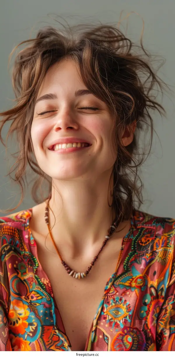 Portrait of a smiling young woman with closed eyes