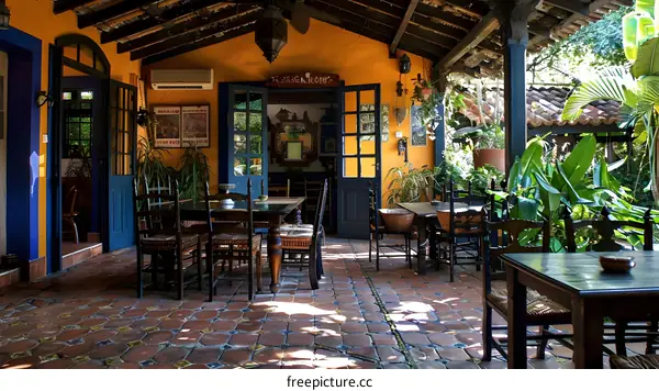 Rustic Mexican style courtyard with colorful doors and chairs