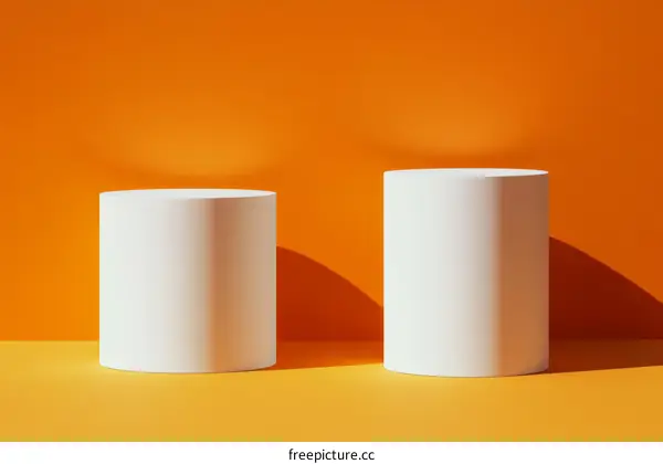 White Cylindrical Product Display Stands on Orange Background