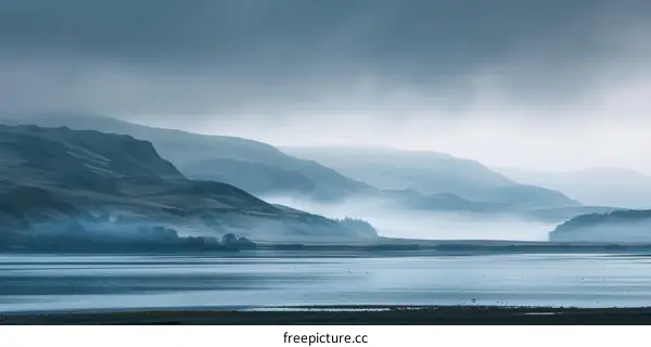 Misty mountains and loch in Scotland