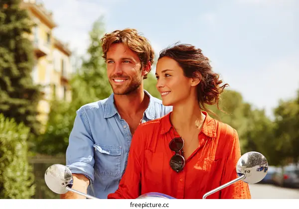 Couple Riding Scooter in Cityscape Photo