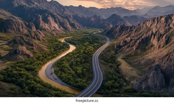 Mountain Road Winding Through Valley at Sunrise