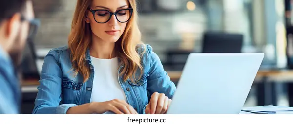 Businesswoman Using Laptop In Office