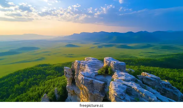 Panoramic Mountain View at Sunrise Over Lush Grassland