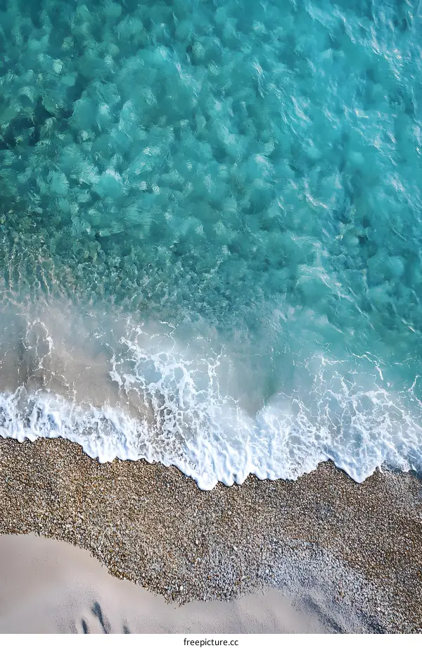 Clear Blue Ocean Water Breaking On Sandy Shore