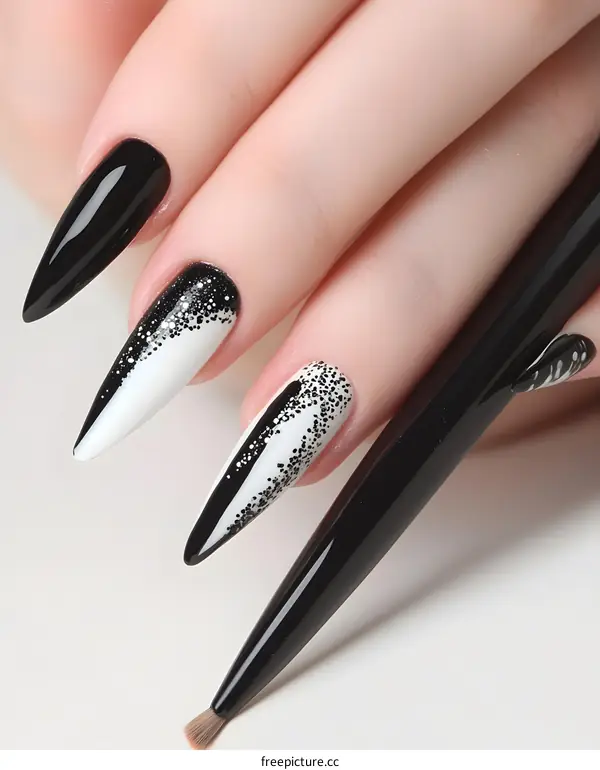 Close Up of Woman Hands with Stylish Black and White Nail Art