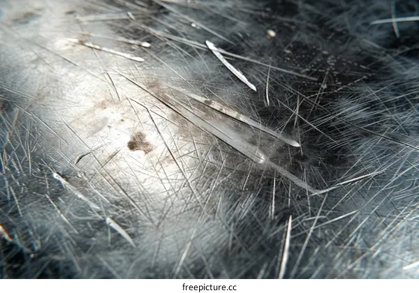 Close-up image of scratches on a dark metal surface