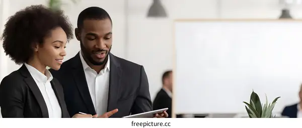 Business Colleagues Discussing Project on Tablet