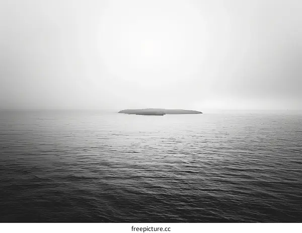 Small rocky island in the middle of the sea with fog
