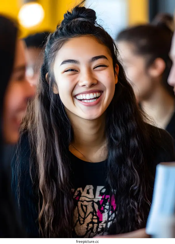 Young Asian Woman Laughing in a Cafe