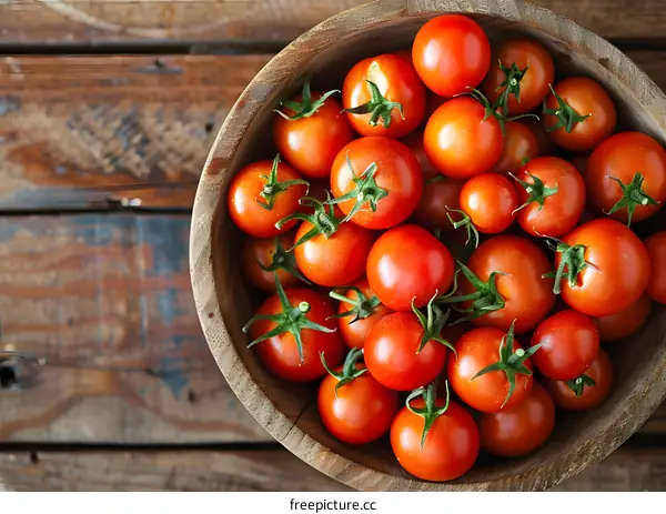 top view of fresh organic tomatoes in a wooden bowl