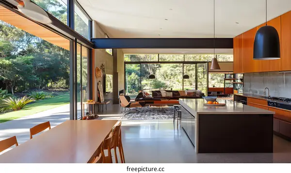 Modern Open Plan Kitchen and Living Room with Glass Doors and a View of Nature