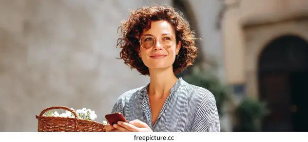 Woman Outdoors with Smartphone and Basket