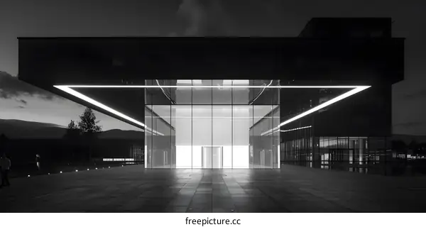 Modern Building Entrance with Neon Lights and Two People Walking
