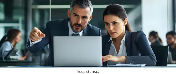 Business People Discussing Ideas On Laptop
