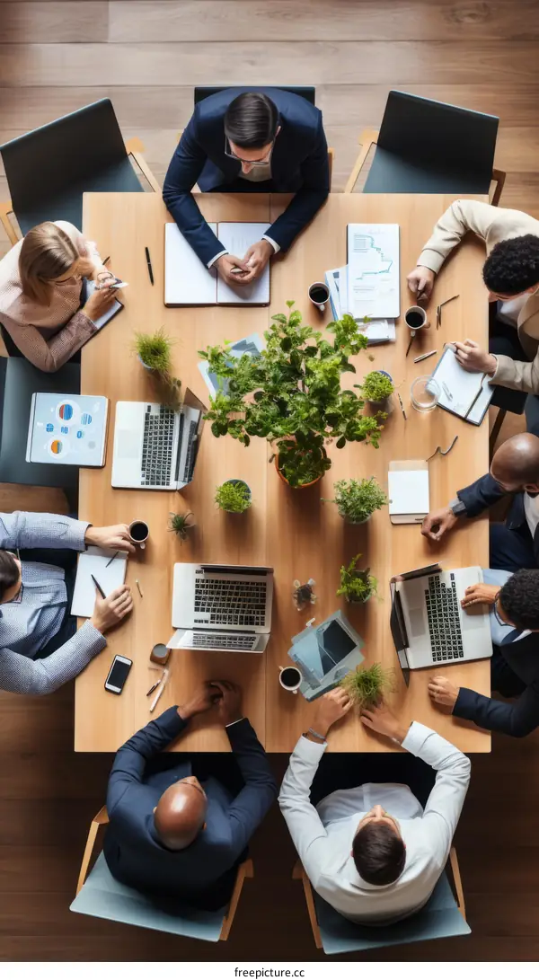 A group of people sitting around a table having a meeting