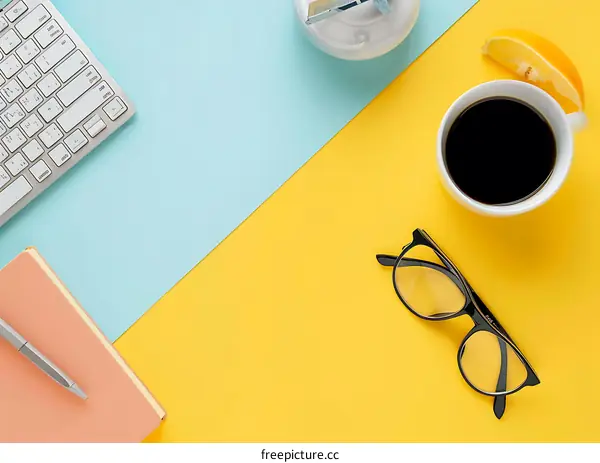 Yellow and Blue Background with Coffee, Pen, Glasses, Keyboard, and Notebook