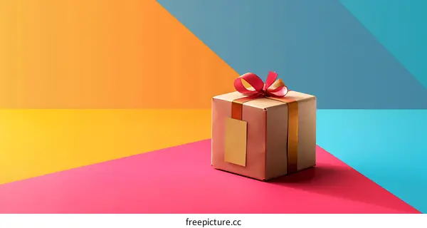Brown Gift Box With Red Ribbon On Colorful Background