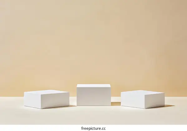 Three White Cubic Display Platforms Against Beige Background
