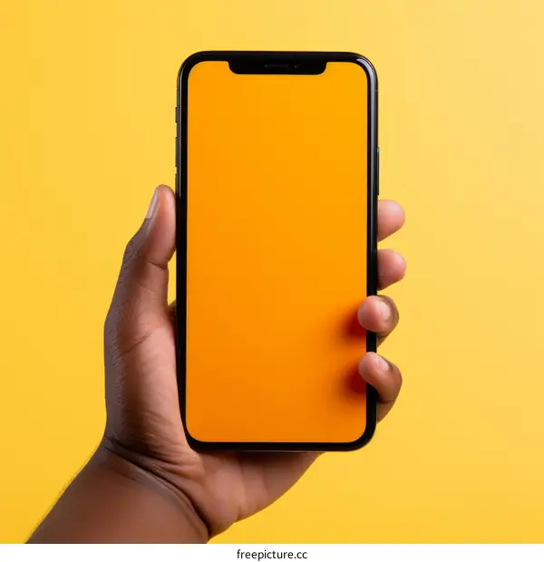 black hand holding a black phone with an orange screen
