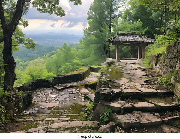 A Stone Path Leading to a Japanese Gazebo Overlooking a Forest