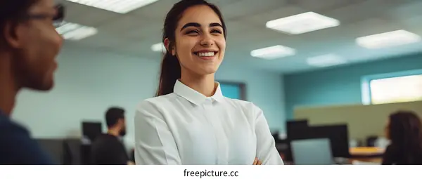 Smiling Woman in Office Setting with Coworker