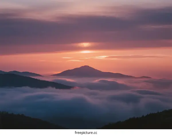 Beautiful Sunrise Over Misty Mountain Range with Pink Sky