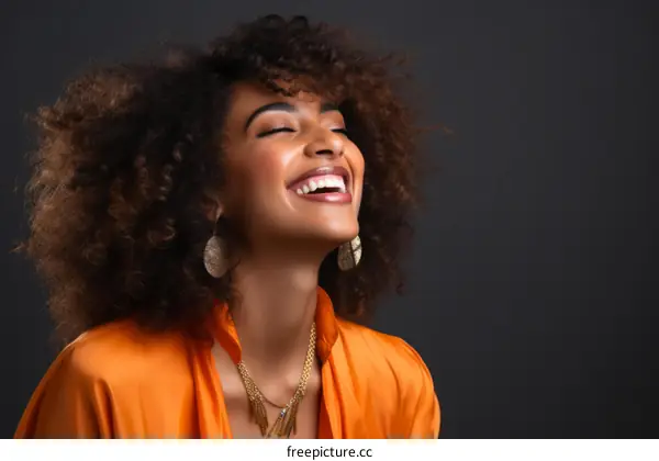 Portrait of a beautiful young woman with curly hair smiling