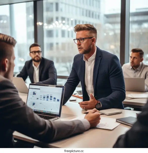 Business meeting in progress with four people in suits