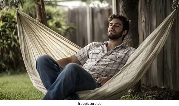 Man Relaxing in Hammock in Backyard