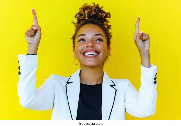 Woman Pointing Upward on Yellow Background