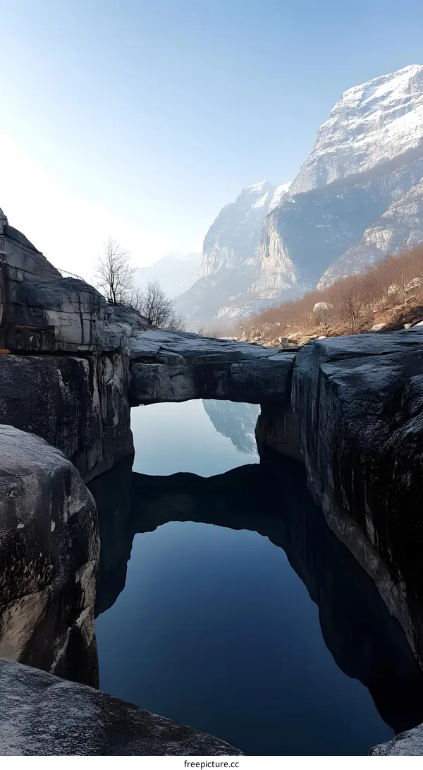 Natural Stone Bridge Over Lake in Mountains