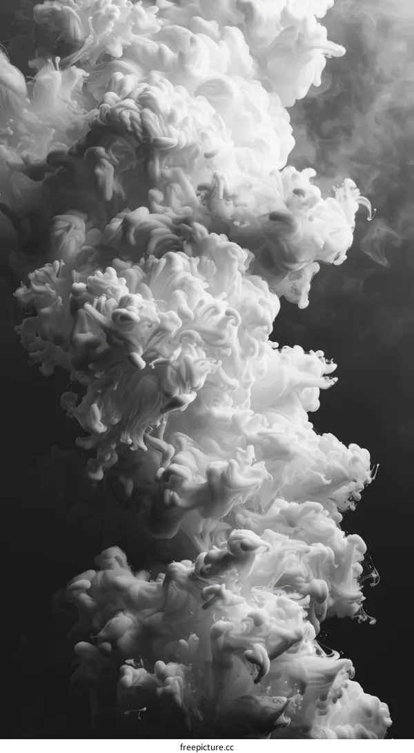 White smoke rising against black background
