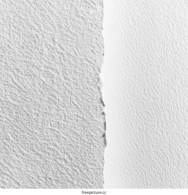 Close-up of a handmade paper texture with a torn edge