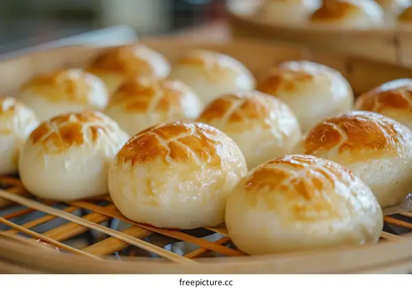 Close-up of a bamboo steamer filled with freshly steamed white buns