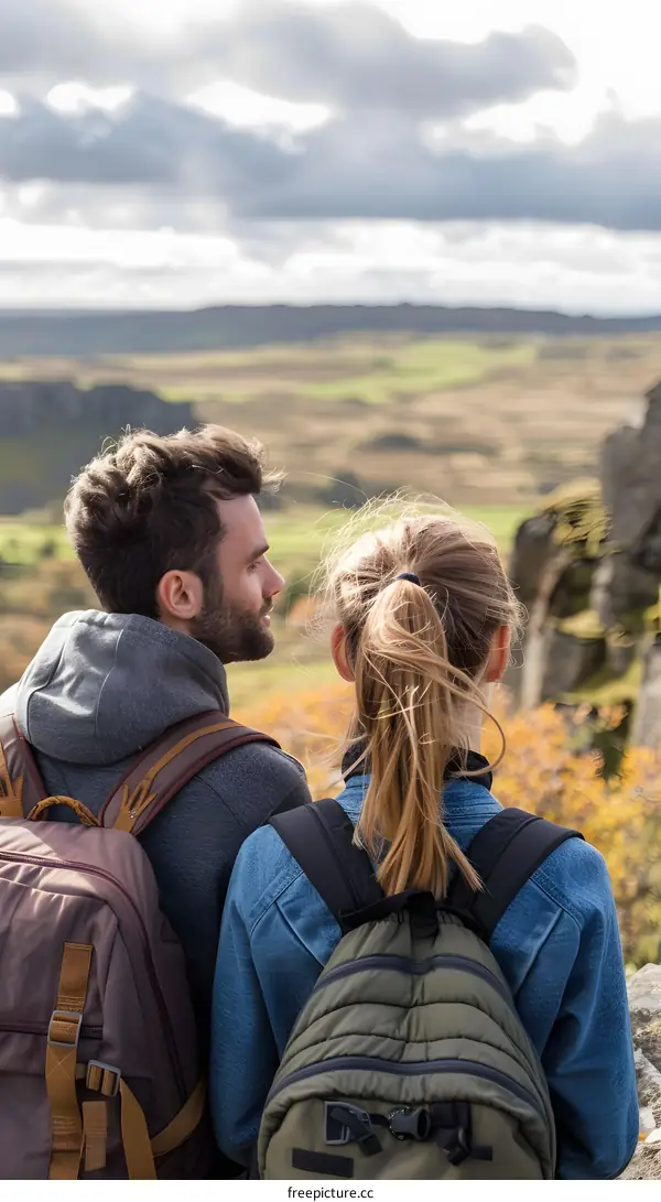 Couple Hiking In Mountains With Back Packs