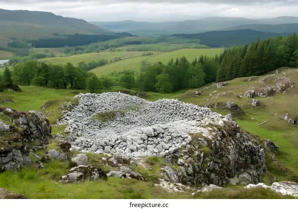 Ancient Stone Cairn on a Hillside with a View of the Scottish Highlands