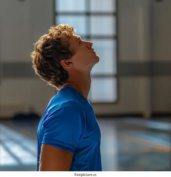 Young male athlete looking up in admiration
