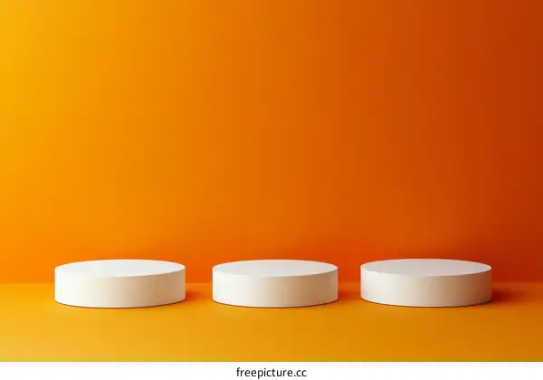 Minimalist White Cylindrical Pedestals on Orange Background