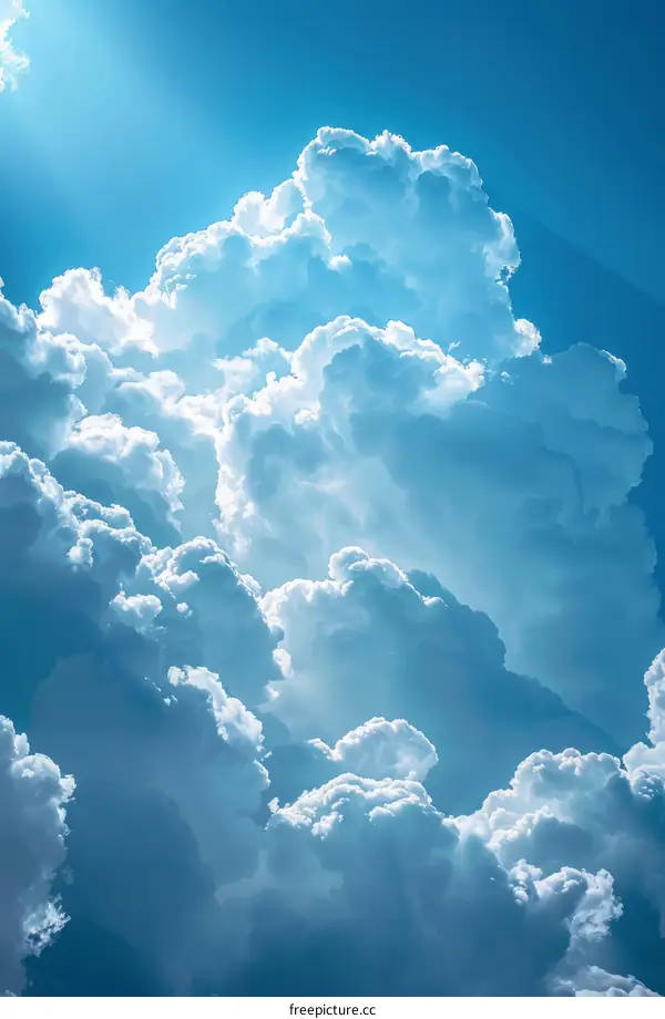 Blue and white cloudscape with sun rays shining through