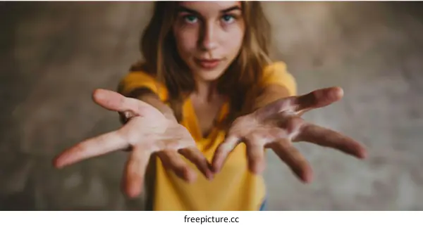 Young woman with outstretched hands