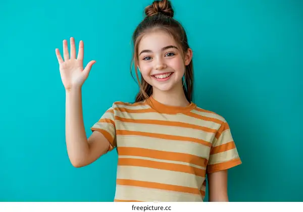 Smiling Girl Waving Hand Against Turquoise Background