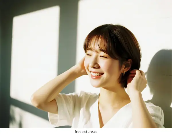 A Young Woman with Short Hair Smiling Brightly Indoors