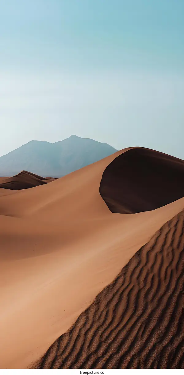 Sand Dunes in the Desert with a Mountain in the Background